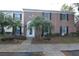 Inviting home features brick accents, black shutters, and lush palm trees in the yard at 13758 Orange Sunset Dr # 202, Tampa, FL 33618