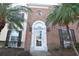Charming brick home with a white front door framed by palm trees at 13758 Orange Sunset Dr # 202, Tampa, FL 33618