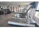 Bright fitness center with treadmills, exercise equipment, and a wall-mounted TV at 13758 Orange Sunset Dr # 202, Tampa, FL 33618