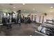 Well-lit gym with multiple weight machines, treadmills, and a mirrored wall at 13758 Orange Sunset Dr # 202, Tampa, FL 33618