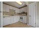 Functional kitchen with white cabinets and essential appliances at 13758 Orange Sunset Dr # 202, Tampa, FL 33618