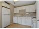 Clean kitchen featuring white cabinetry and modern appliances at 13758 Orange Sunset Dr # 202, Tampa, FL 33618