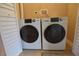 Laundry closet with two newer, front-loading washer and dryer units at 13758 Orange Sunset Dr # 202, Tampa, FL 33618