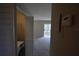 Bright living room with sliding door to balcony and laundry closet with washer visible at 13758 Orange Sunset Dr # 202, Tampa, FL 33618