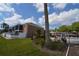 A beautiful condo complex with a pool surrounded by trees and a green lawn at 13758 Orange Sunset Dr # 202, Tampa, FL 33618