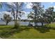 Gorgeous waterfront view with boat, kayaks, and lush landscaping at 13758 Orange Sunset Dr # 202, Tampa, FL 33618