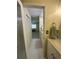 Bathroom with vanity leading into room with neutral carpet and minimalist decor at 1408 Millstream Ln # 206, Dunedin, FL 34698