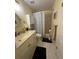 Full bathroom with shower and tub, vanity, and updated fixtures at 1408 Millstream Ln # 206, Dunedin, FL 34698