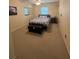 Bright bedroom featuring neutral carpet, a ceiling fan, and window for natural light at 1408 Millstream Ln # 206, Dunedin, FL 34698