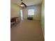 Cozy bedroom featuring neutral carpet, a ceiling fan, and natural light from a window at 1408 Millstream Ln # 206, Dunedin, FL 34698