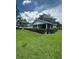The community clubhouse presents a screened porch and well-manicured lawn at 1408 Millstream Ln # 206, Dunedin, FL 34698