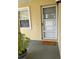 Cozy entryway with a welcome mat and a potted plant, creating a warm and inviting entrance to the unit at 1408 Millstream Ln # 206, Dunedin, FL 34698