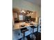 Updated kitchen featuring granite counters, a breakfast bar, and stylish lighting at 1408 Millstream Ln # 206, Dunedin, FL 34698