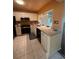 Well-equipped kitchen featuring granite countertops, modern appliances, and ample cabinet space for a functional cooking experience at 1408 Millstream Ln # 206, Dunedin, FL 34698