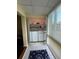 Bright laundry area with in-unit washer and dryer and shelving for ample storage at 1408 Millstream Ln # 206, Dunedin, FL 34698