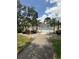 Attractive gated pool area with manicured landscaping and mature trees, enhancing the tranquil setting at 1408 Millstream Ln # 206, Dunedin, FL 34698