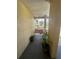 Private porch with a bench, potted plants, and a view of the community's serene surroundings, creating a relaxing retreat at 1408 Millstream Ln # 206, Dunedin, FL 34698