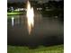 The lake with fountain illuminated at night, enhancing the community's picturesque appeal at 1408 Millstream Ln # 206, Dunedin, FL 34698