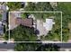 An aerial view of a lot featuring two small homes shaded by mature trees at 14210 Downing St, Dover, FL 33527