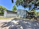 Shaded backyard view showcasing the house exterior and ample outdoor space at 14210 Downing St, Dover, FL 33527
