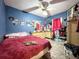 Bedroom featuring a ceiling fan and a vanity at 14210 Downing St, Dover, FL 33527