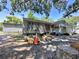 Gray home exterior featuring red trimmed windows at 14210 Downing St, Dover, FL 33527
