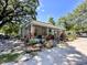 Charming porch view adorned with plants, logs, and unique decor at 14210 Downing St, Dover, FL 33527
