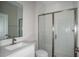 Modern bathroom with a glass-enclosed shower, sleek fixtures, and tiled floor at 14411 Meadow Bird Ave, Riverview, FL 33579