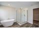 Modern bathroom features a glass shower and a sleek, freestanding bathtub at 14411 Meadow Bird Ave, Riverview, FL 33579