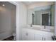 Elegant bathroom features dual sinks, marble countertops, and a bathtub with tiled walls at 14411 Meadow Bird Ave, Riverview, FL 33579