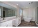 Well-lit bathroom featuring a double vanity, freestanding tub, and glass-enclosed shower at 14411 Meadow Bird Ave, Riverview, FL 33579