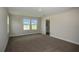 Bright, carpeted bedroom with an ensuite bathroom featuring neutral walls and natural light at 14411 Meadow Bird Ave, Riverview, FL 33579