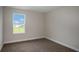 Bright, carpeted bedroom with a window view and a neutral color palette that complements the space at 14411 Meadow Bird Ave, Riverview, FL 33579