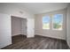 Bright bedroom with wood-look floors, two sunny windows, and a spacious closet at 14411 Meadow Bird Ave, Riverview, FL 33579