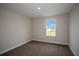 Inviting carpeted bedroom featuring a window that brings in natural light to the space at 14411 Meadow Bird Ave, Riverview, FL 33579