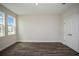 Spacious bedroom with wood-look flooring and a large window providing natural light at 14411 Meadow Bird Ave, Riverview, FL 33579