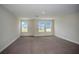 Bright bedroom with carpet flooring and three large windows at 14411 Meadow Bird Ave, Riverview, FL 33579