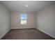 Comfortable carpeted bedroom with a large window offering plenty of natural light at 14411 Meadow Bird Ave, Riverview, FL 33579