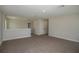 Upstairs bonus room area with neutral carpeting and a view of the landing at 14411 Meadow Bird Ave, Riverview, FL 33579