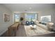 Spacious bonus room featuring two windows, ample seating, and decorative accents at 14411 Meadow Bird Ave, Riverview, FL 33579