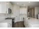 Modern kitchen featuring white cabinets, stainless steel appliances, and sleek countertops at 14411 Meadow Bird Ave, Riverview, FL 33579