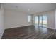 Inviting living room with wood-look flooring and sliding doors that open to the patio and backyard at 14411 Meadow Bird Ave, Riverview, FL 33579