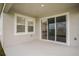 Covered patio with sliding glass doors providing indoor-outdoor living space at 14411 Meadow Bird Ave, Riverview, FL 33579