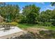 Spacious backyard with green grass, landscaping, and a patio set for outdoor enjoyment at 1535 Nursery Rd # 110, Clearwater, FL 33756