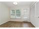 Bright bedroom with wood floors, closet, and door to outside, offering natural light and outdoor access at 1535 Nursery Rd # 110, Clearwater, FL 33756