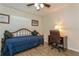 Bedroom features a daybed with wooden frame, wood-look floors, desk and chair at 1535 Nursery Rd # 110, Clearwater, FL 33756