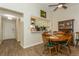 Dining area with wood table and chairs, wood-look floors, and view to kitchen at 1535 Nursery Rd # 110, Clearwater, FL 33756
