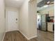 Entryway featuring hard surface floors and views of the kitchen with stainless steel appliances for a modern living space at 1535 Nursery Rd # 110, Clearwater, FL 33756