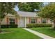 Lovely single-story home with a well-kept lawn and walkway leading to the front door, framed by lush landscaping at 1535 Nursery Rd # 110, Clearwater, FL 33756