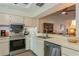 Bright kitchen with stainless steel appliances, seamlessly connected to living areas with modern design at 1535 Nursery Rd # 110, Clearwater, FL 33756